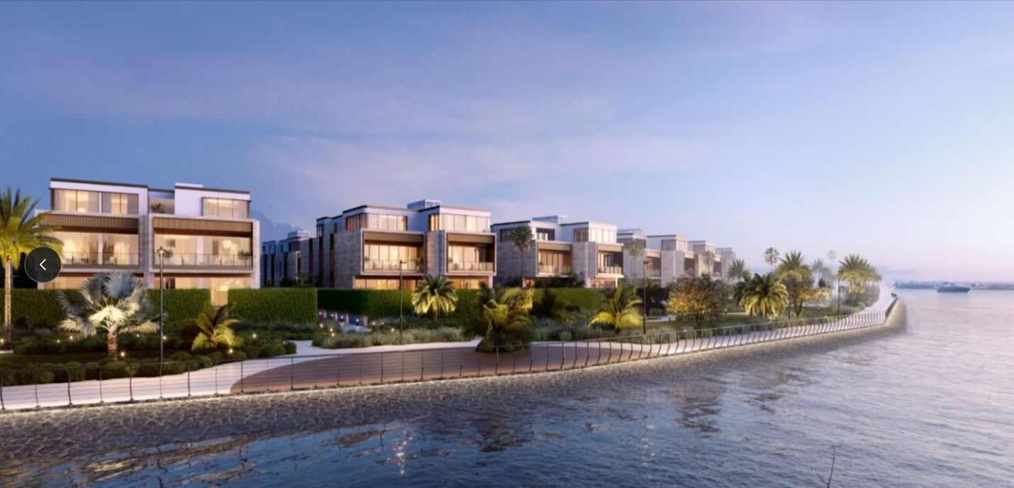 A row of buildings next to a body of waterAI-generated content may be incorrect.