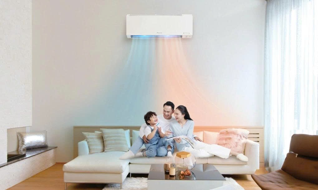 A family sitting on a couch with a air conditioner above itAI-generated content may be incorrect.