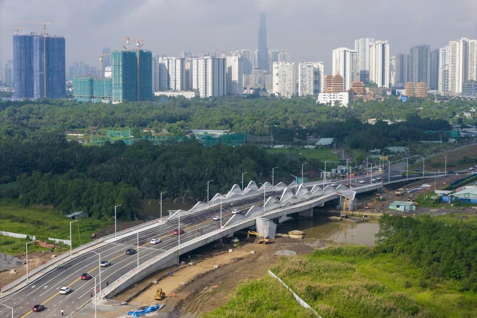 A bridge over a river with a city in the backgroundAI-generated content may be incorrect.