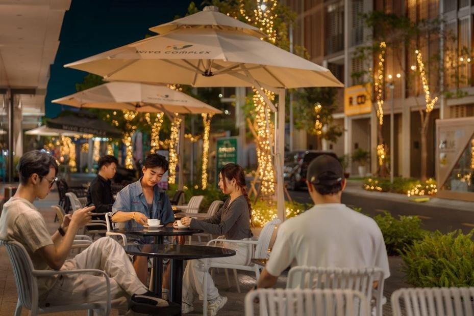 People sitting at a table outside at nightAI-generated content may be incorrect.